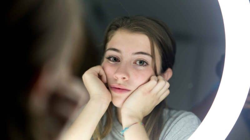 Woman with eating disorder looking in mirror