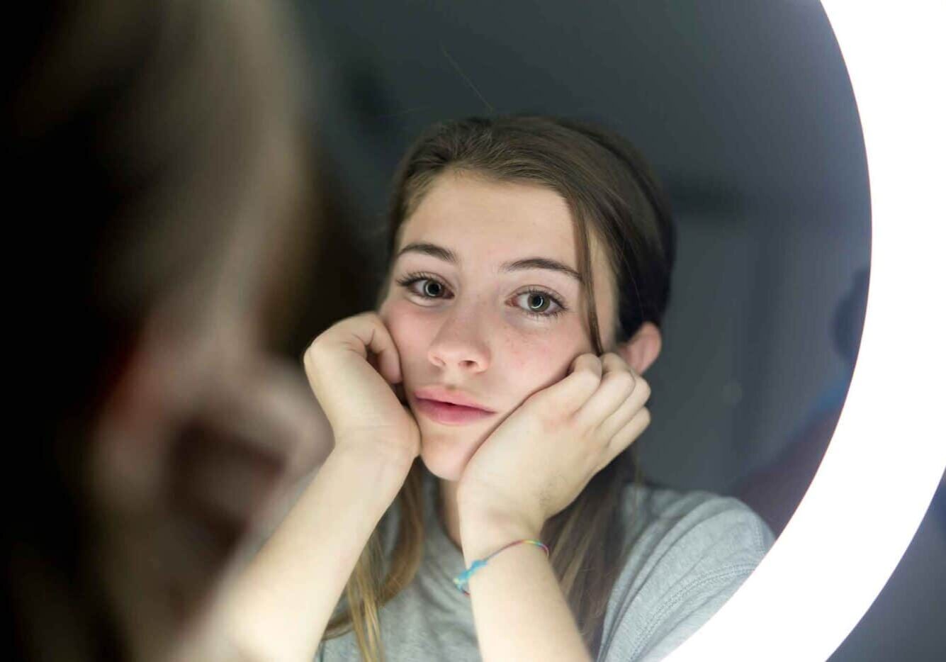 Woman with eating disorder looking in mirror